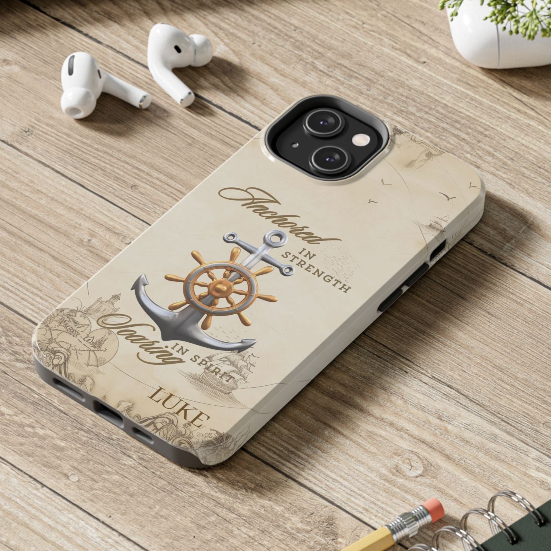 Phone case with anchor and ship wheel design with text 'Anchored in Strength soaring in Spirit' that can be personalized.