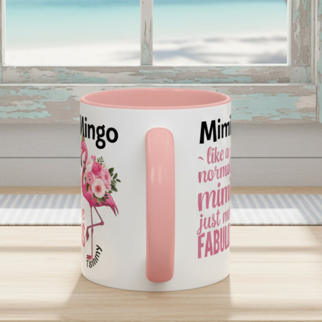 White mug with pink interior and handle, featuring text and a flamingo design on a white background.