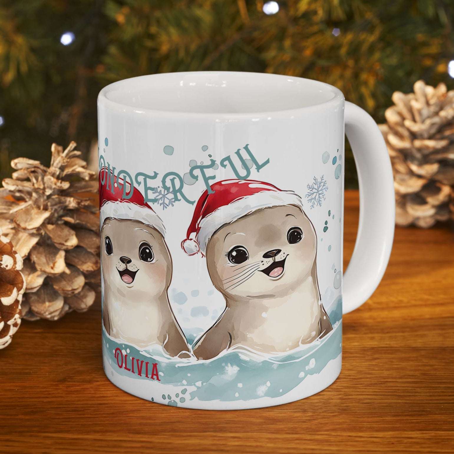Mug with cartoon seals wearing Santa hats on a wooden surface with Christmas decorations.