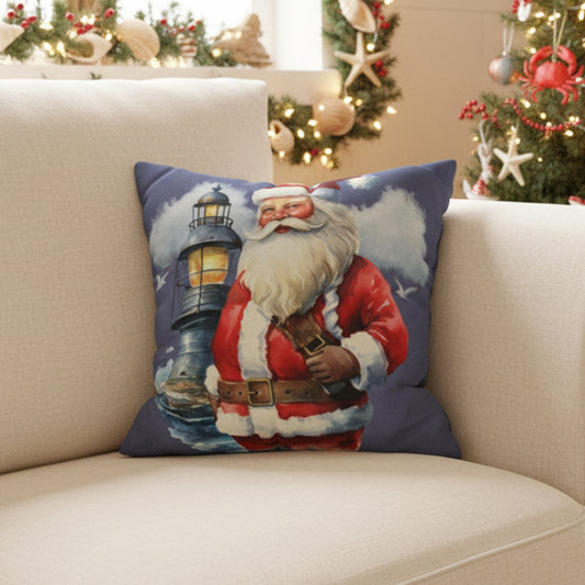 Decorative pillow with Santa Claus and lighthouse design on a couch.