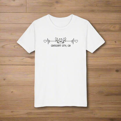 White Child t-shirt with a smiley crab on a heartbeat line with hearts at both ends and “Crescent City, CA” underneath the design.