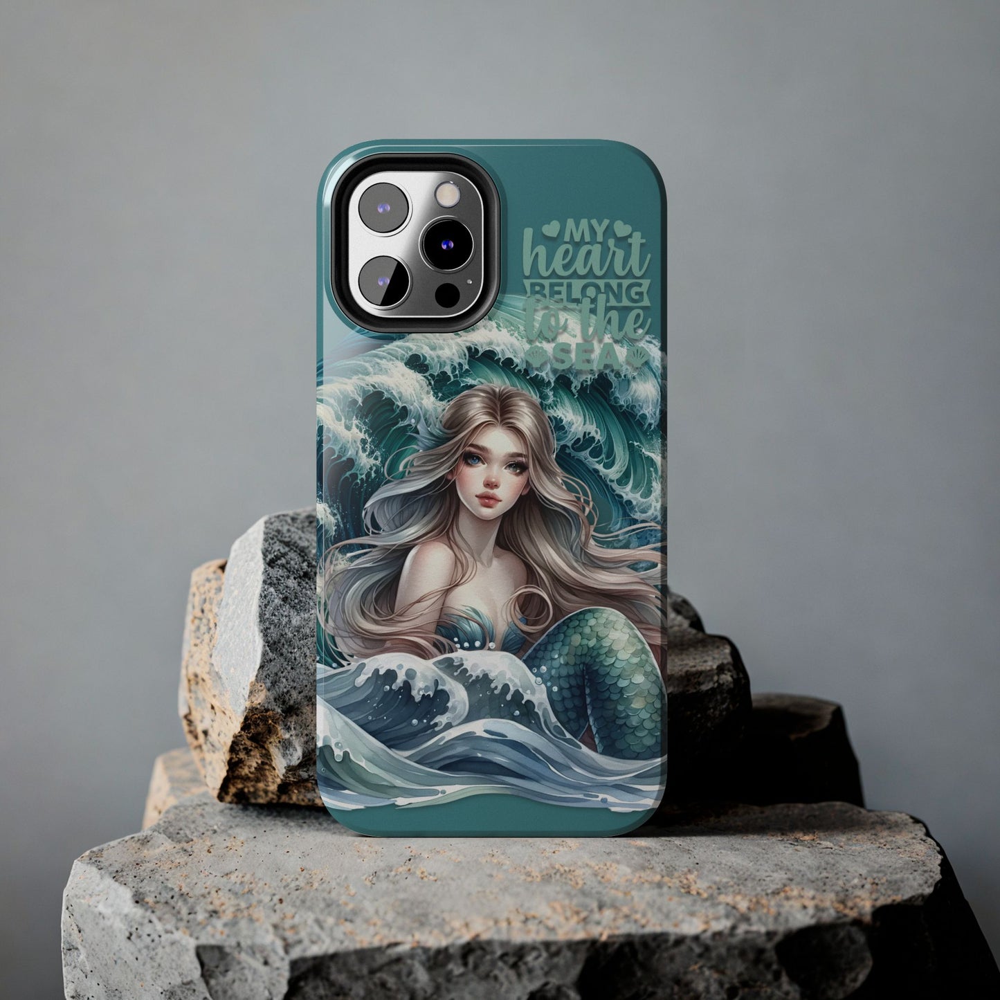 Phone Case with Flowy mermaid with ocean wave behind and text My Heart Belongs to the Sea against rock