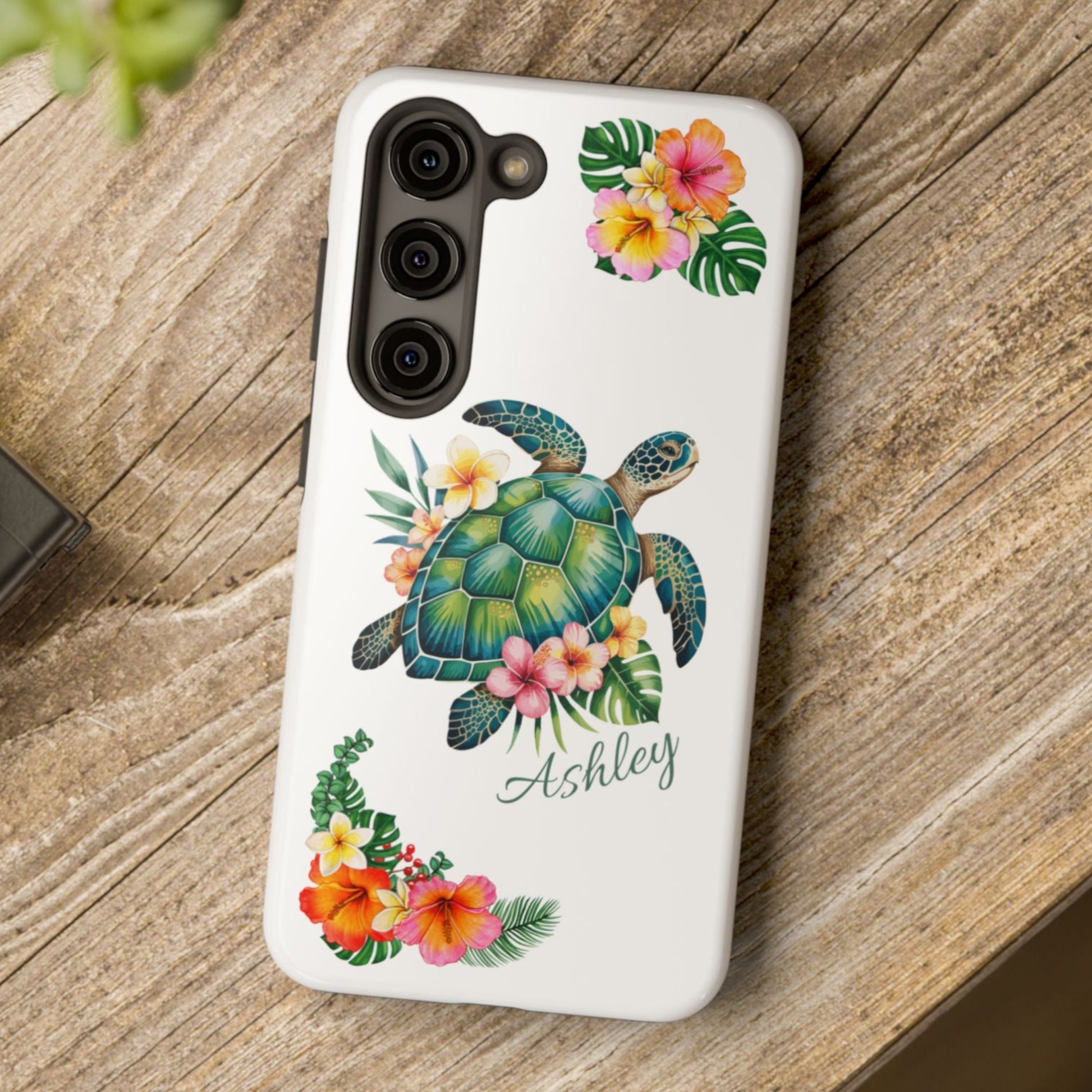 Samsung phone case with a white background and a sea turtle with hibiscus flowers, with more hibiscus flowers around the sides.