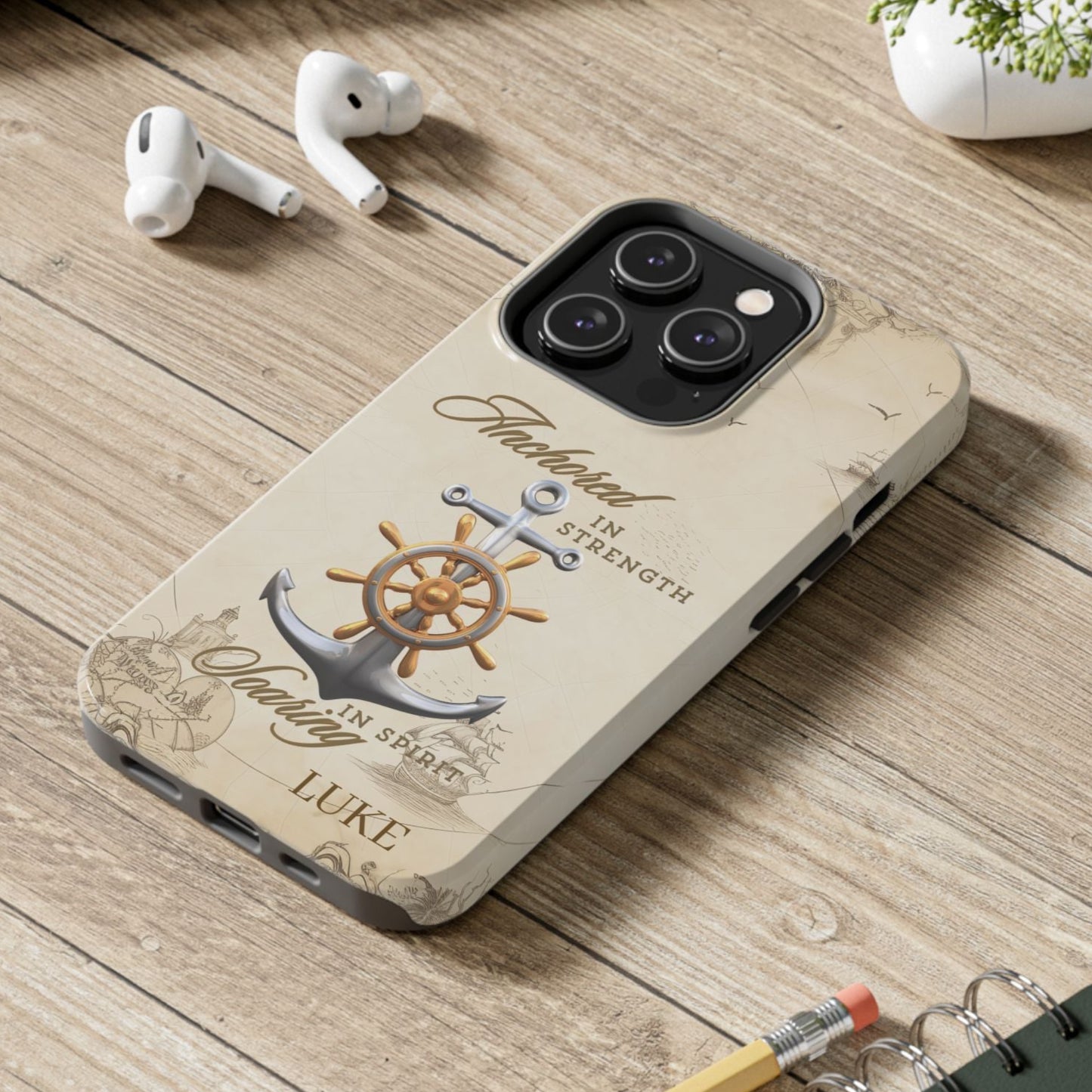 Phone case with anchor and ship wheel design with text 'Anchored in Strength soaring in Spirit' that can be personalized.