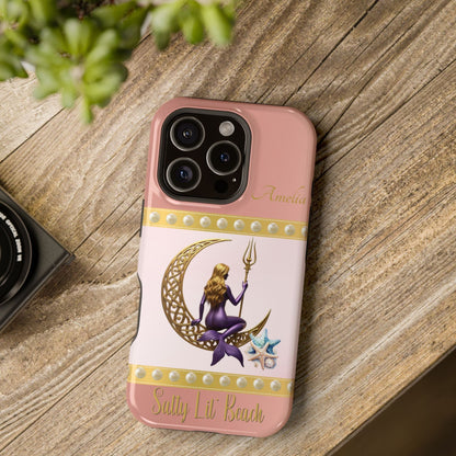 Phone case with a design of a mermaid and crescent moon on a pink background, placed on a wooden surface.