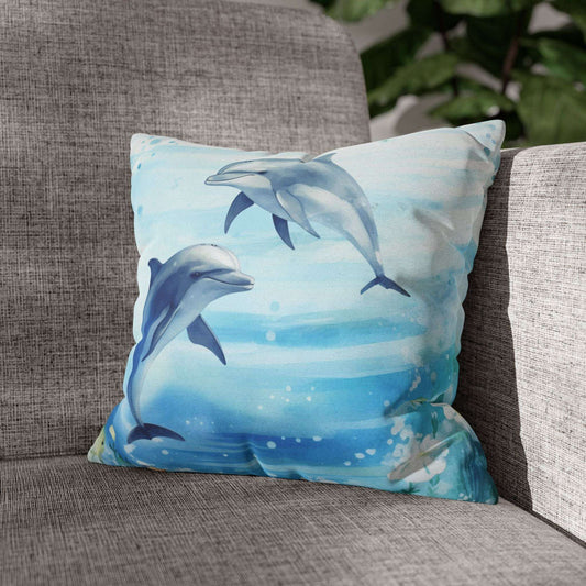Pillowcase with a watercolor design of two dolphins in the water with flowers along the bottom edges.