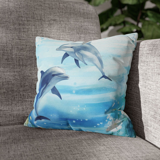 Pillowcase with a watercolor design of two dolphins in the water with flowers along the bottom edges.