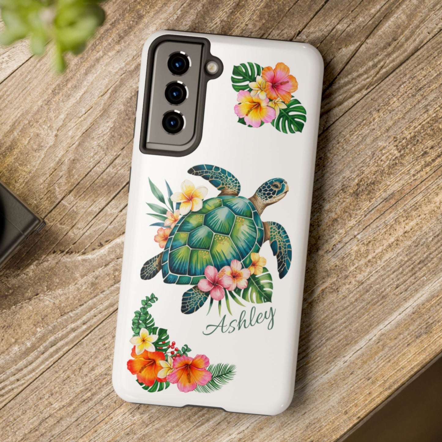Samsung phone case with a white background and a sea turtle with hibiscus flowers, with more hibiscus flowers around the sides.