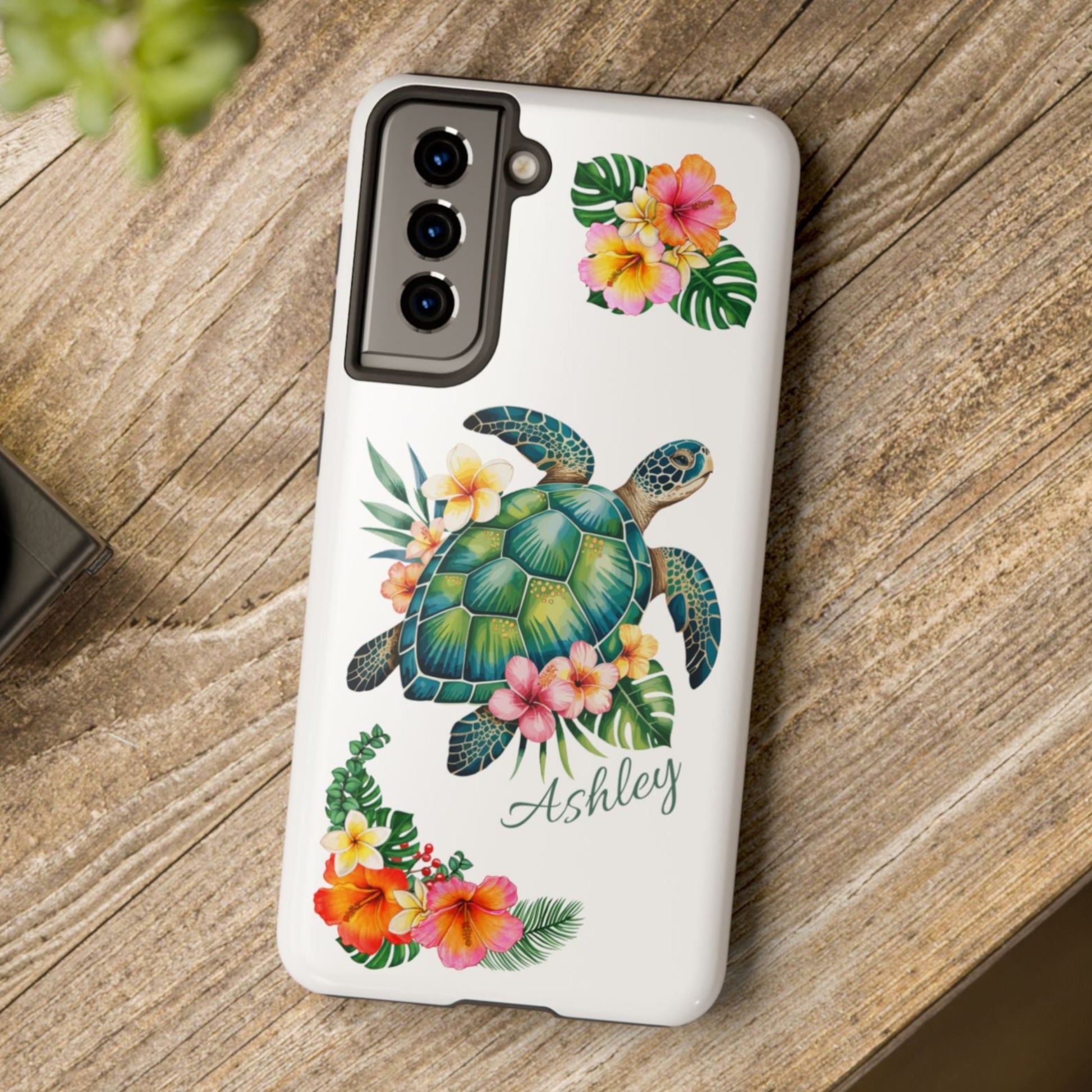 Samsung phone case with a white background and a sea turtle with hibiscus flowers, with more hibiscus flowers around the sides.