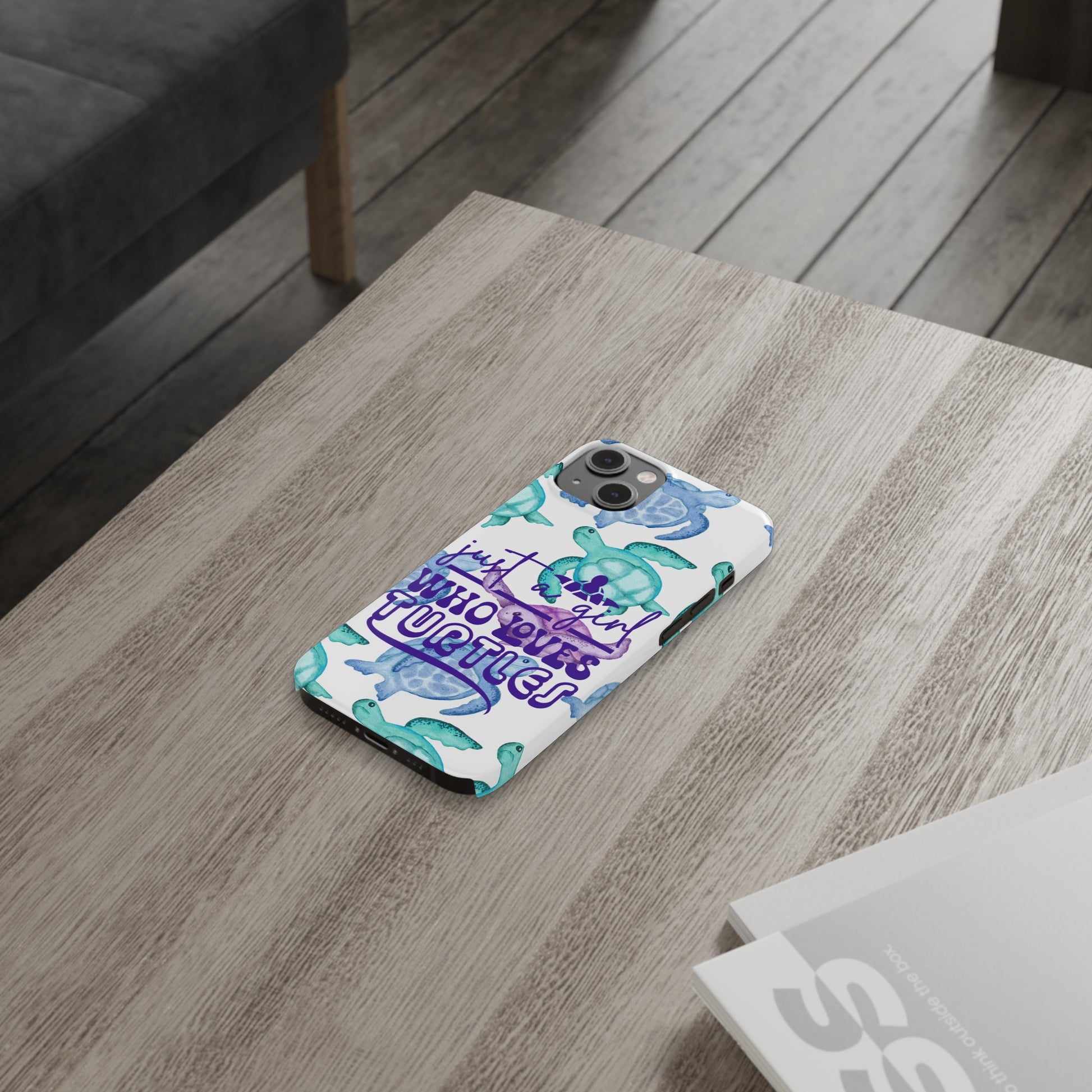 Iphone case with turquoise, blue and purple sea turtles that says  Just a Girl Who Loves Sea turtles laying on table