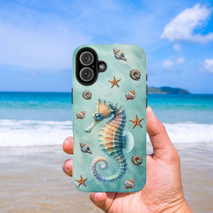 Phone case with seahorse design held in front of a beach