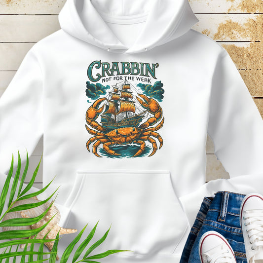 White hoodie with a large crab enveloping a pirate ship with the text “Crabbin’s Not for the Weak” in an old-style font.