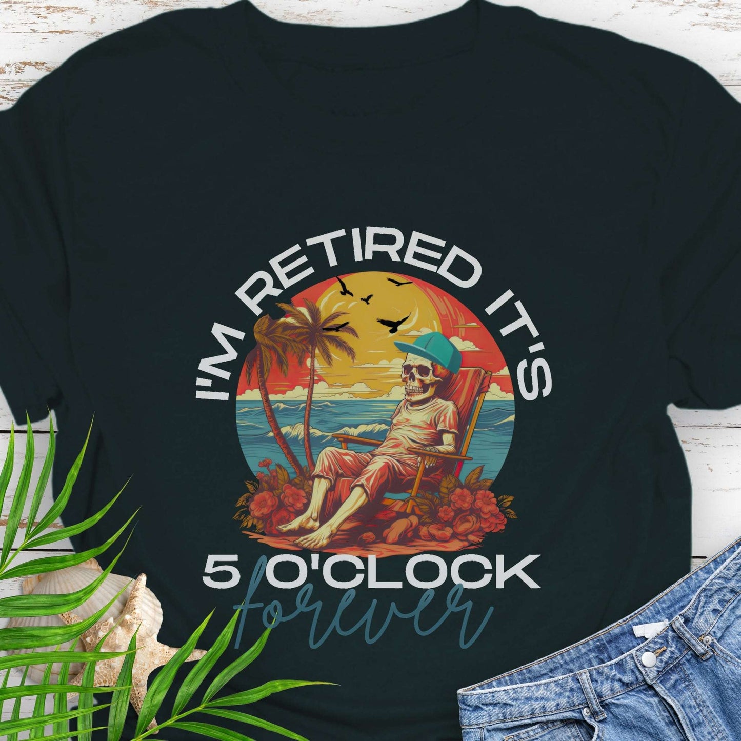 Black t-shirt with a skeleton lounging on beach with text 'I'm Retired It's 5 0'Clock Forever.