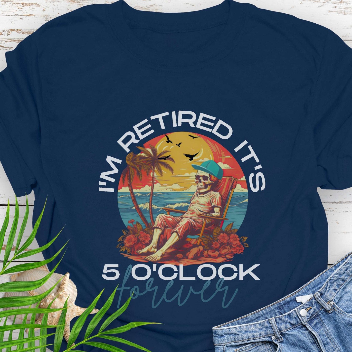 Navy blue t-shirt with a skeleton lounging on beach with text 'I'm Retired It's 5 0'Clock Forever.