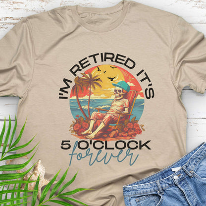 Beige t-shirt with a skeleton lounging on beach with text 'I'm Retired It's 5 0'Clock Forever.