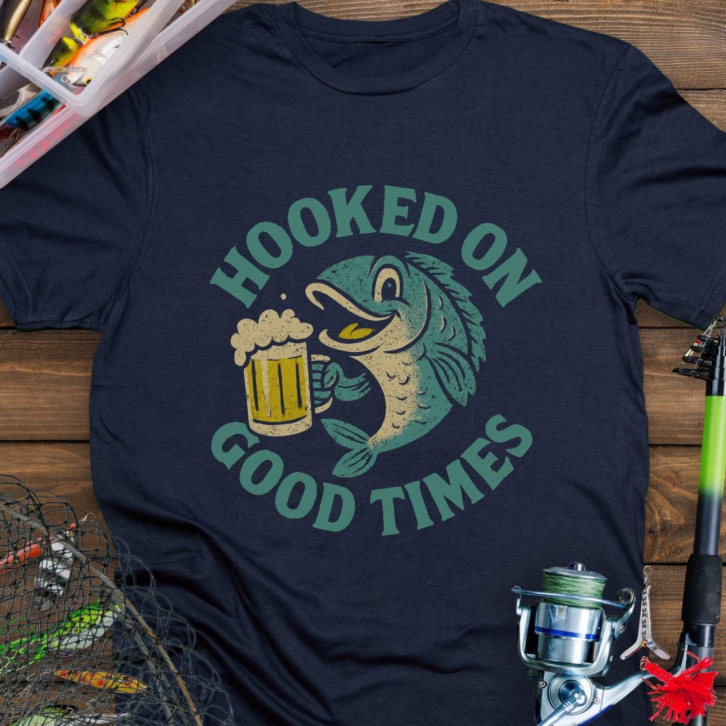 Navy T-shirt with a cartoon fish holding a beer mug and the words "Hooked On Good Times."