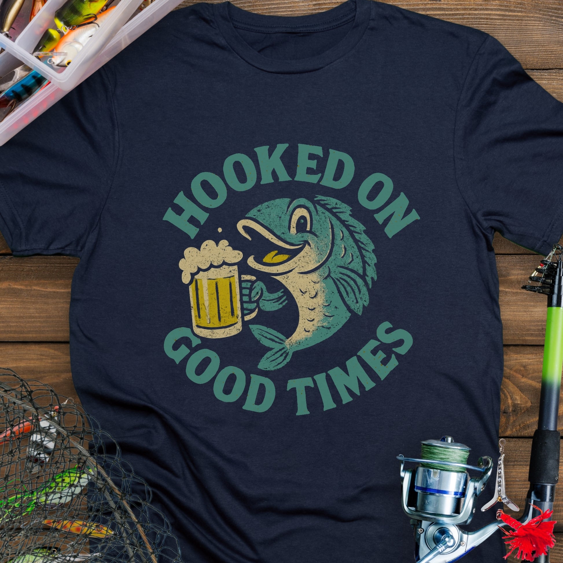 Navy T-shirt with a cartoon fish holding a beer mug and the words "Hooked On Good Times."