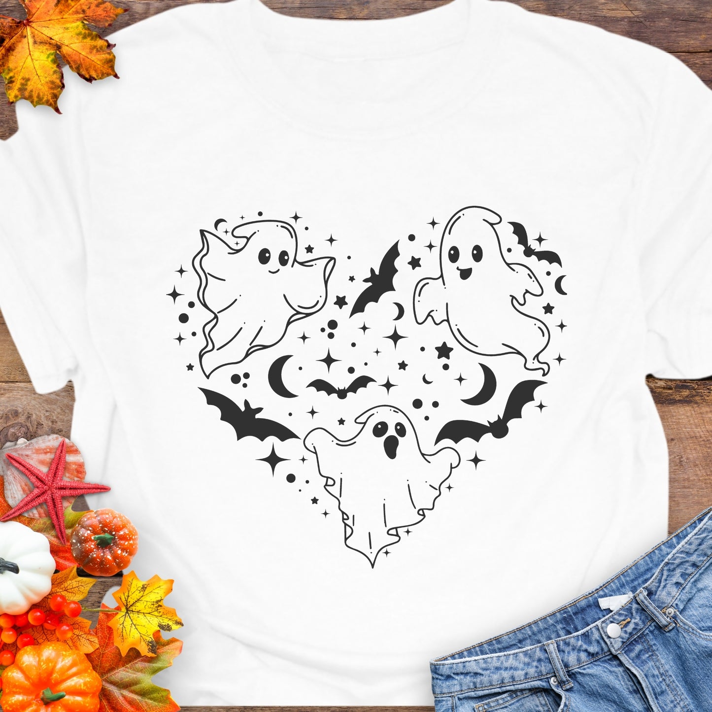 White unisex T-shirt with a design of white ghosts and black bats forming the shape of a heart.