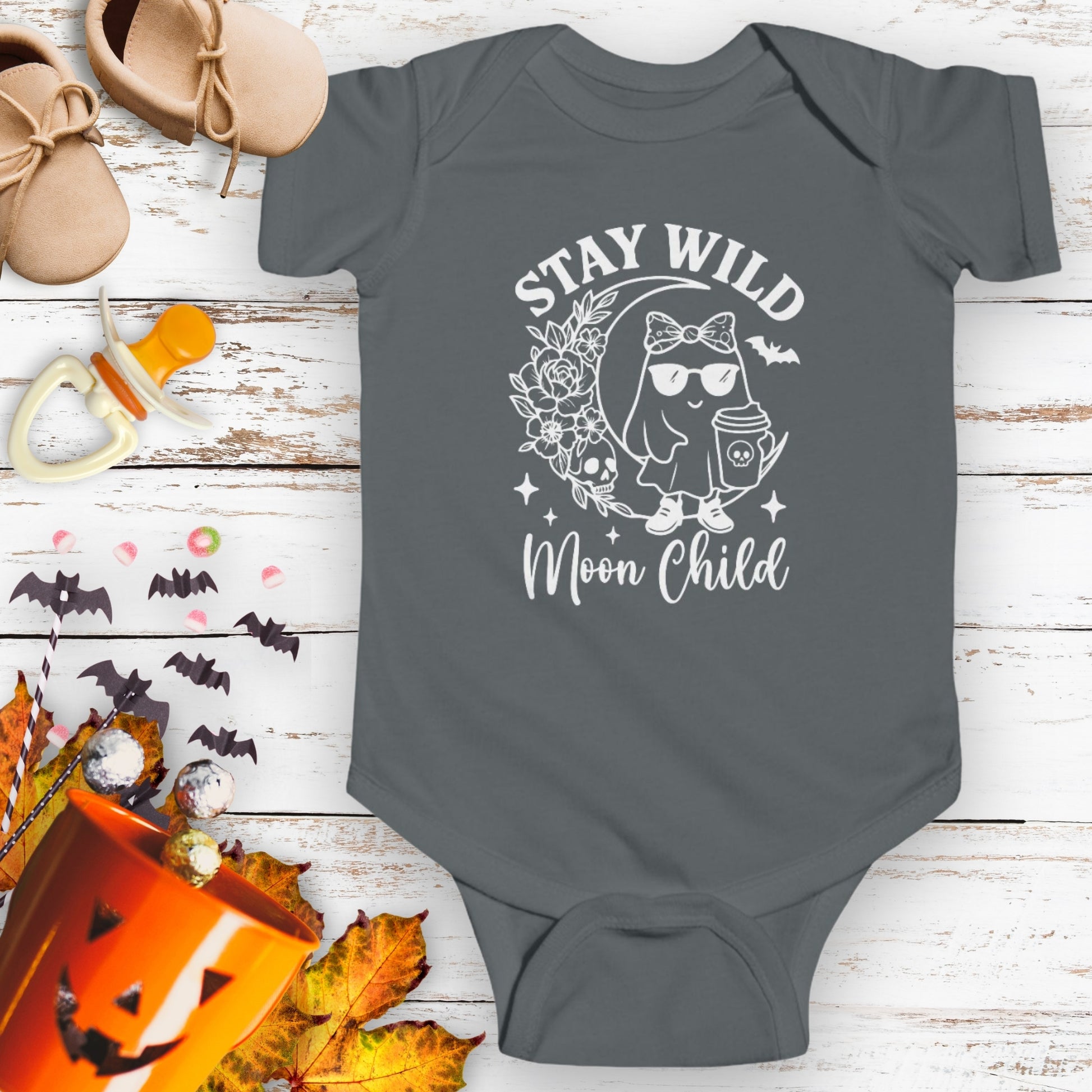 Gray infant bodysuit featuring a girl ghost sitting on a crescent moon with floral accents and a skull design, with the text “Stay Wild Moon Child.”