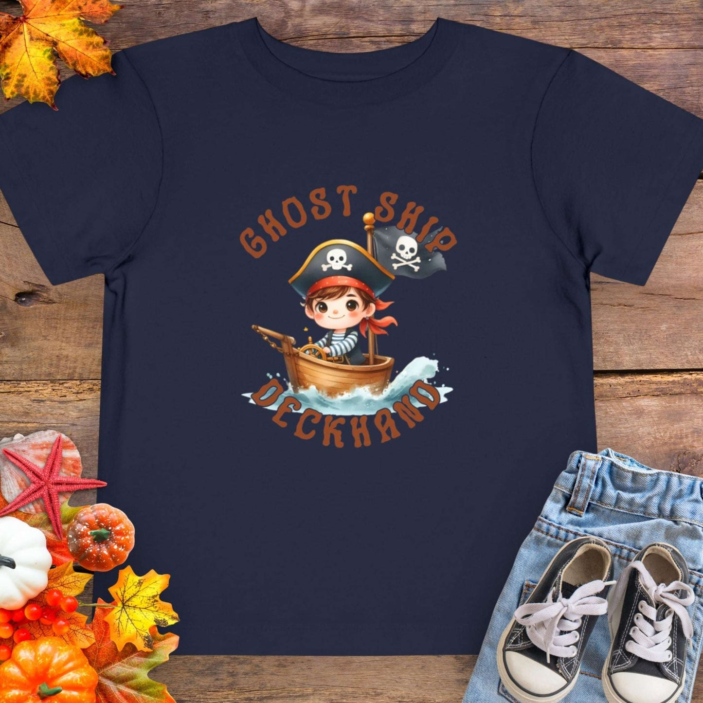 Navy blue t-shirt with a cartoon pirate boy in a boat with text 'Ghost Ship Deckhand'. 