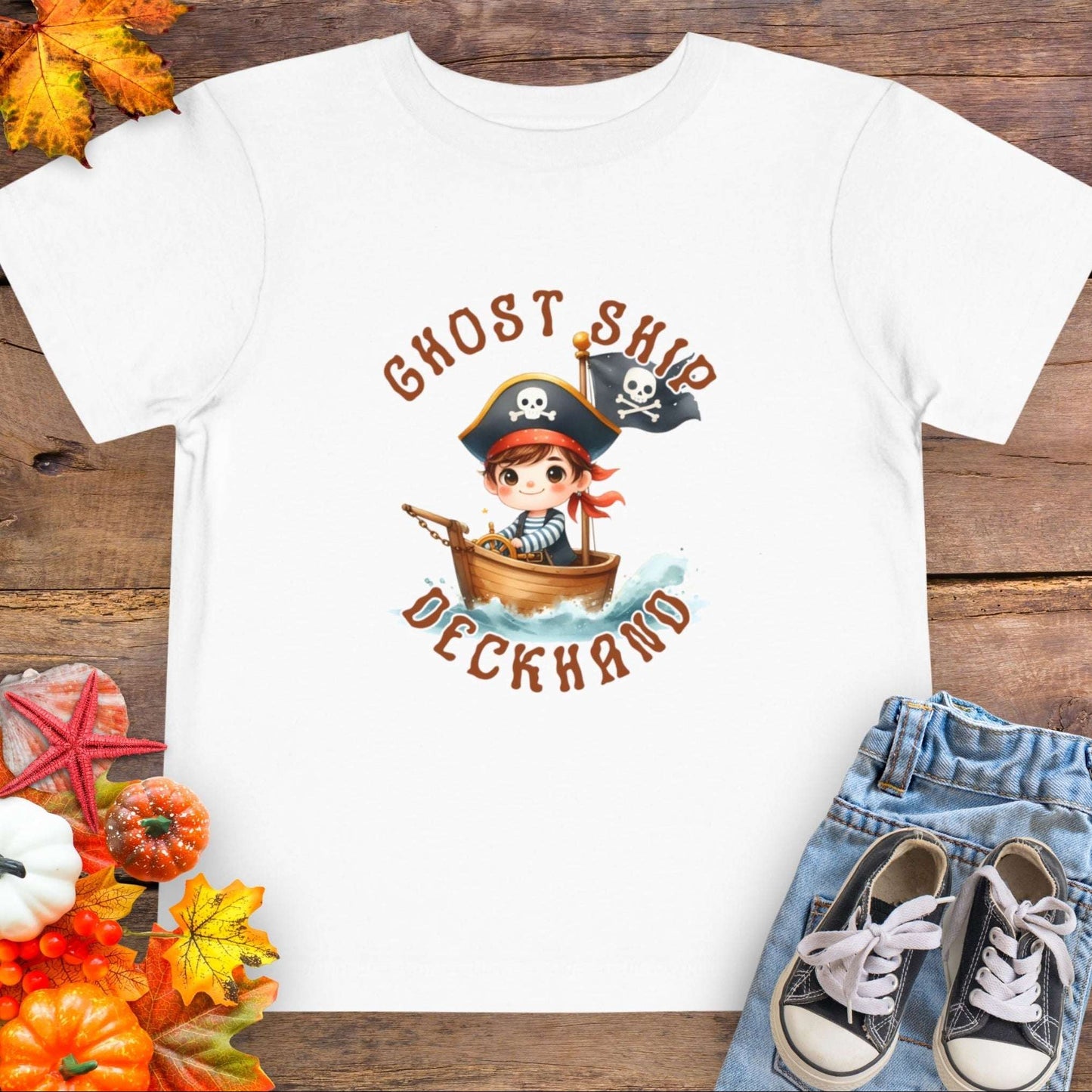 White t-shirt with a cartoon pirate boy in a boat with text 'Ghost Ship Deckhand'. 