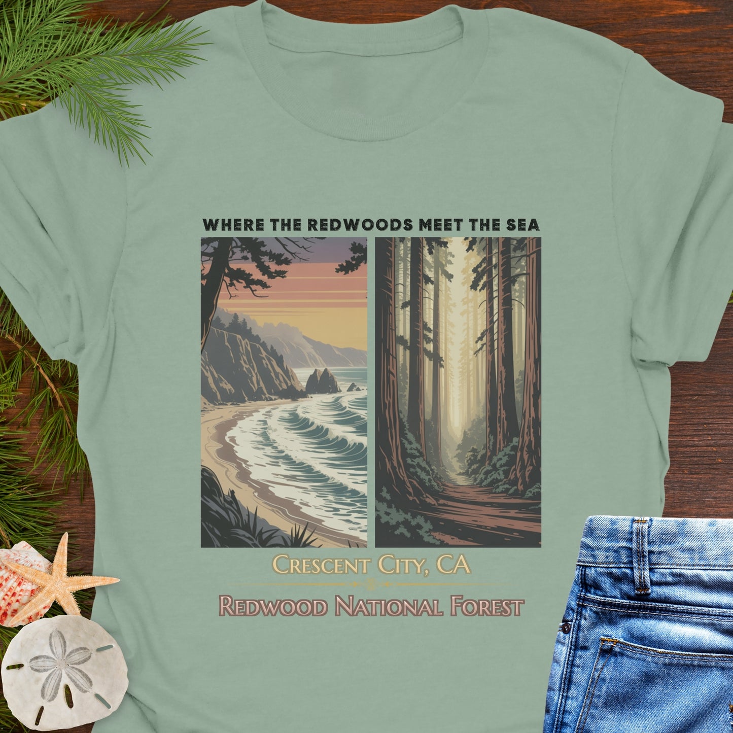 Green t-shirt with Redwood National Forest design on a wooden surface with beach elements.