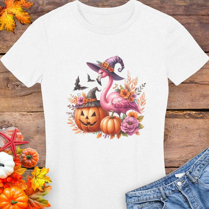 White t-shirt with a flamingo wearing a witch hat and surrounded by pumpkins and flowers.