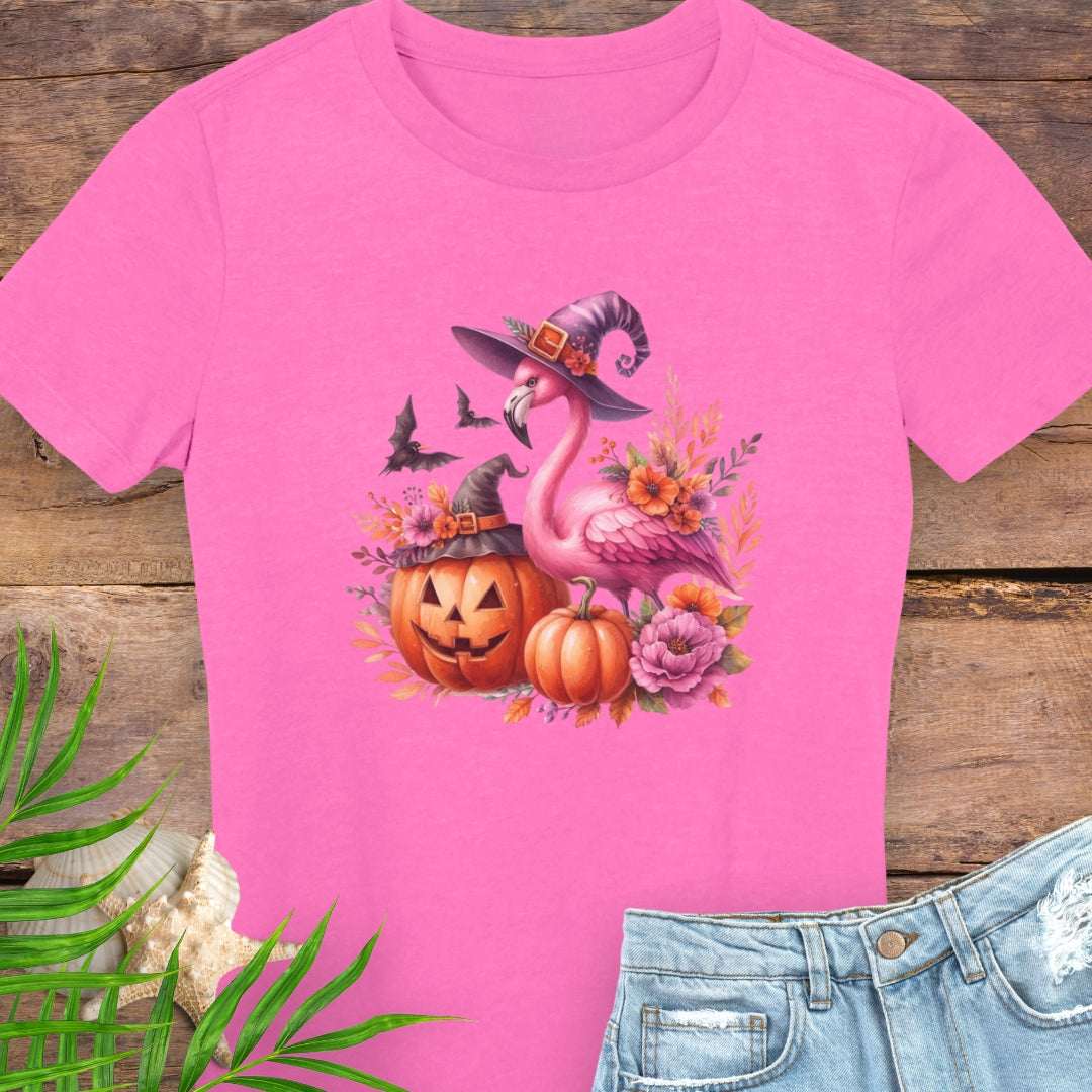 Pink t-shirt with Halloween-themed flamingo design on a wooden surface.
