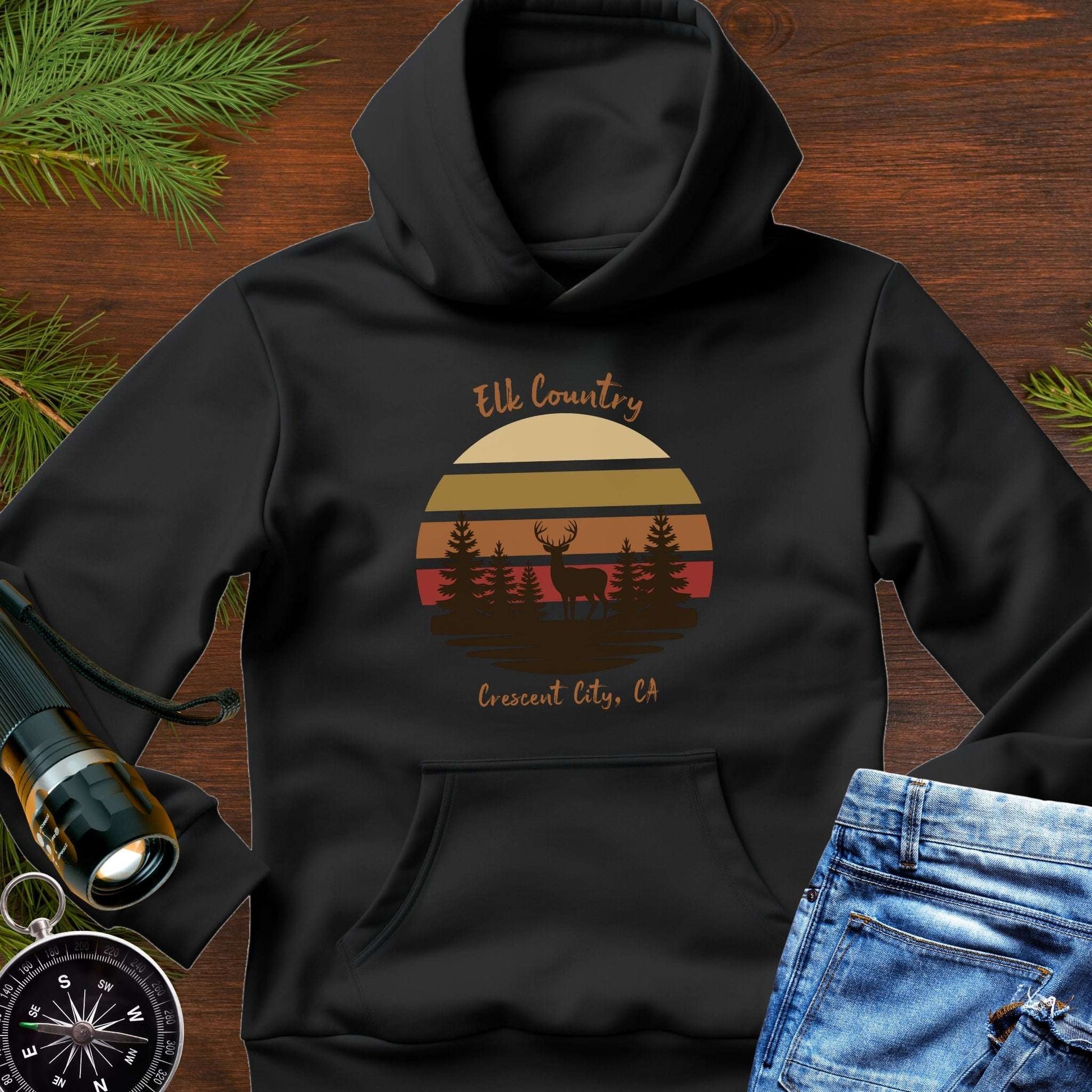 Black hoodie with 'Elk Country' with retro sunset and silhouette of trees and elk design with Crescent City, CA underneath.