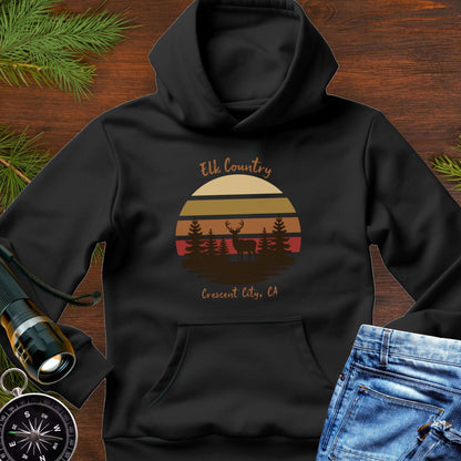 Black hoodie with 'Elk Country' with retro sunset and silhouette of trees and elk design with Crescent City, CA underneath.