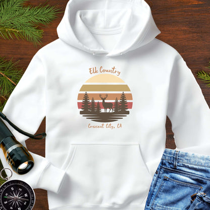 White hoodie with 'Elk Country' with retro sunset and silhouette of trees and elk design with Crescent City, CA underneath.