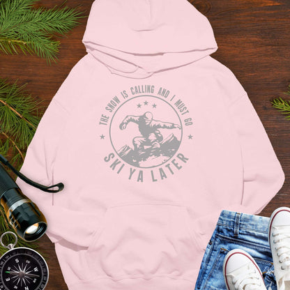 Pink hoodie with skiing design and text Snow Is Calling – Ski Ya Later.
