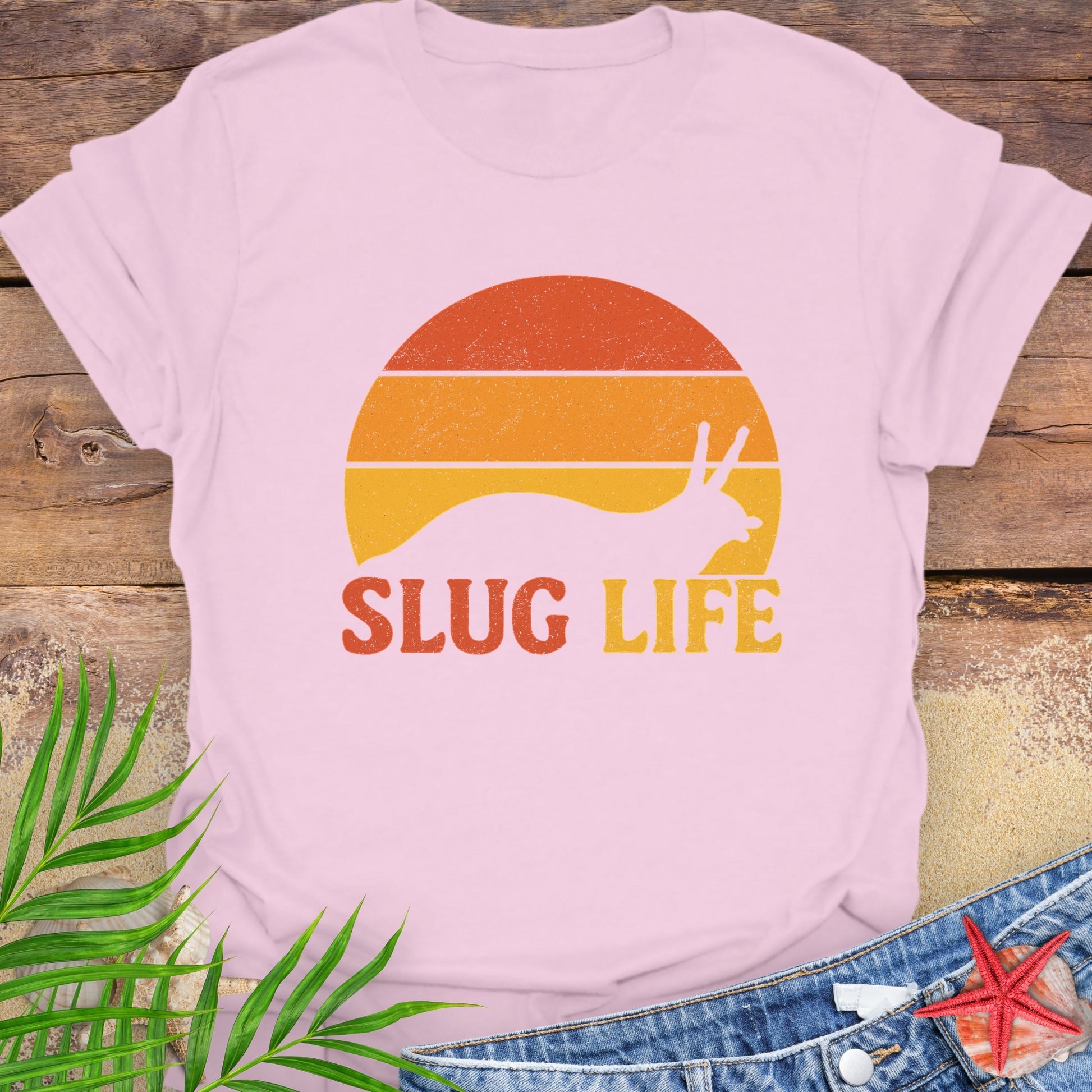 Pink t-shirt with 'Slug Life' sunset graphic.