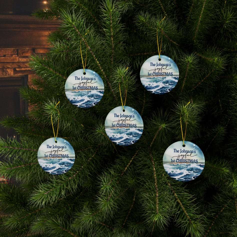 Five personalized Christmas ornaments on a tree with a fireplace in the background