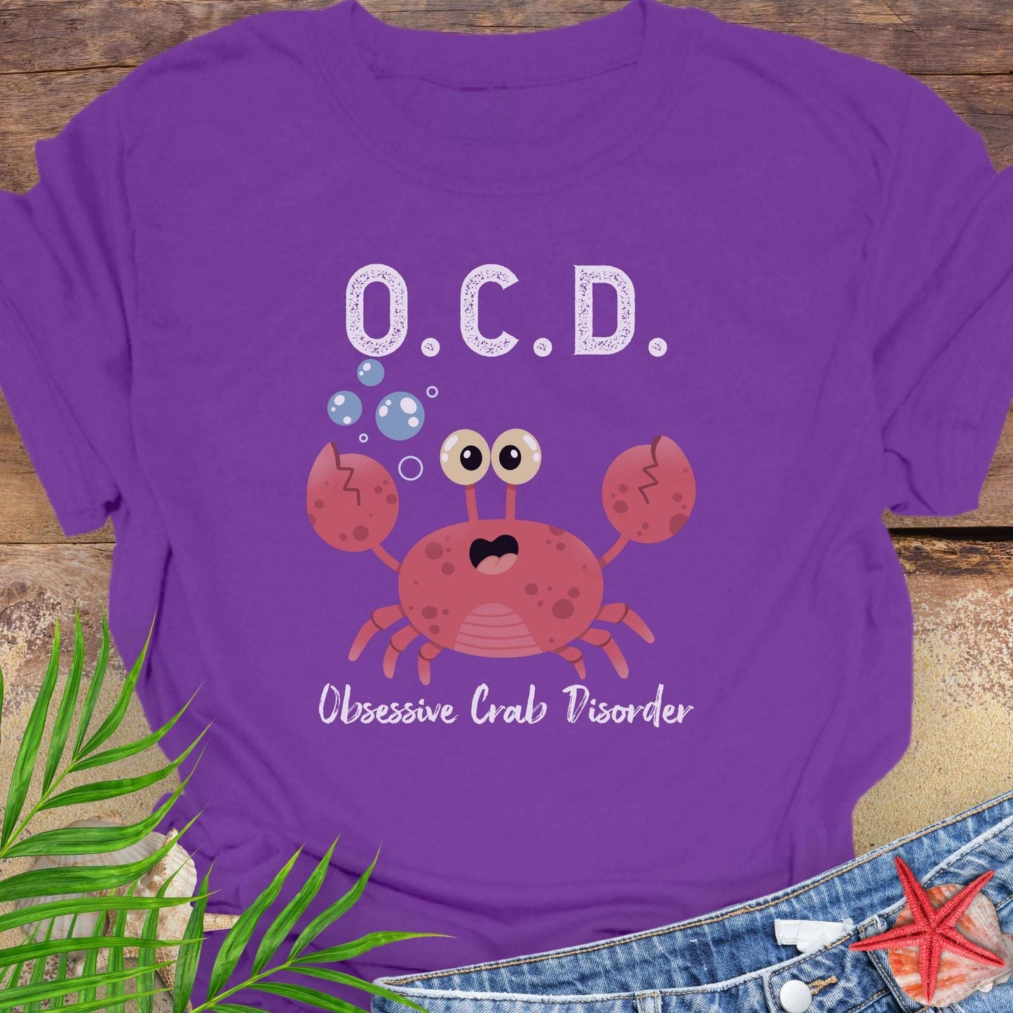 Purple t-shirt with a cartoon crab and text OCD Obsessive Crab Disorder.