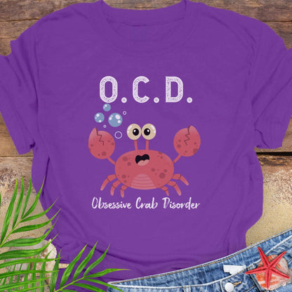 Purple t-shirt with a cartoon crab and text OCD Obsessive Crab Disorder.