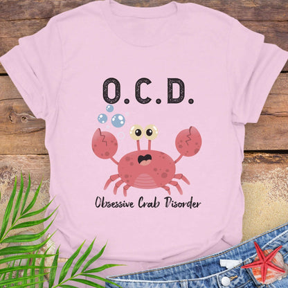 Pink t-shirt with a cartoon crab and text OCD Obsessive Crab Disorder.