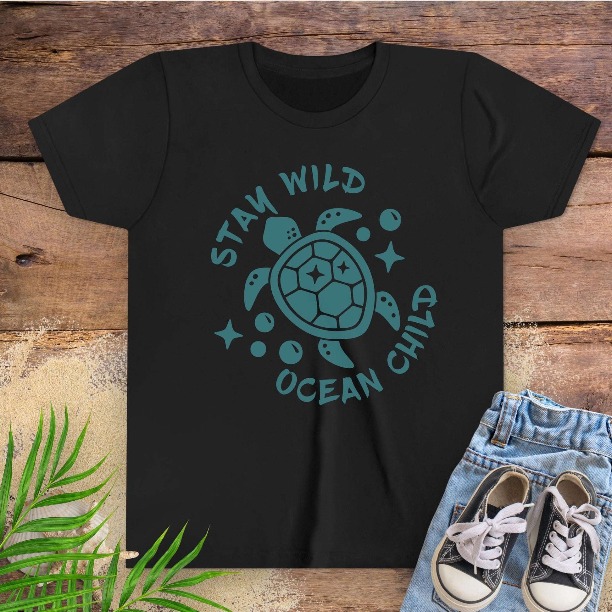 Black t-shirt with sea turtle graphic and text stay wild ocean child.