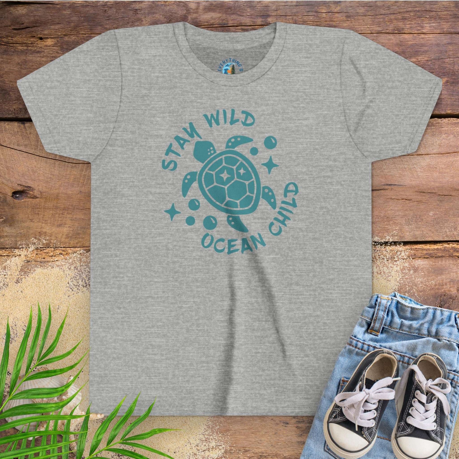 Gray t-shirt with sea turtle graphic and text stay wild ocean child.
