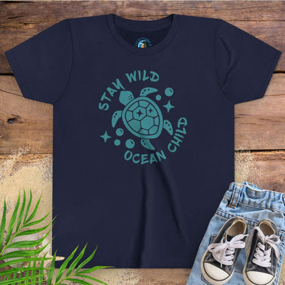 Navy blue t-shirt with sea turtle graphic and text stay wild ocean child.