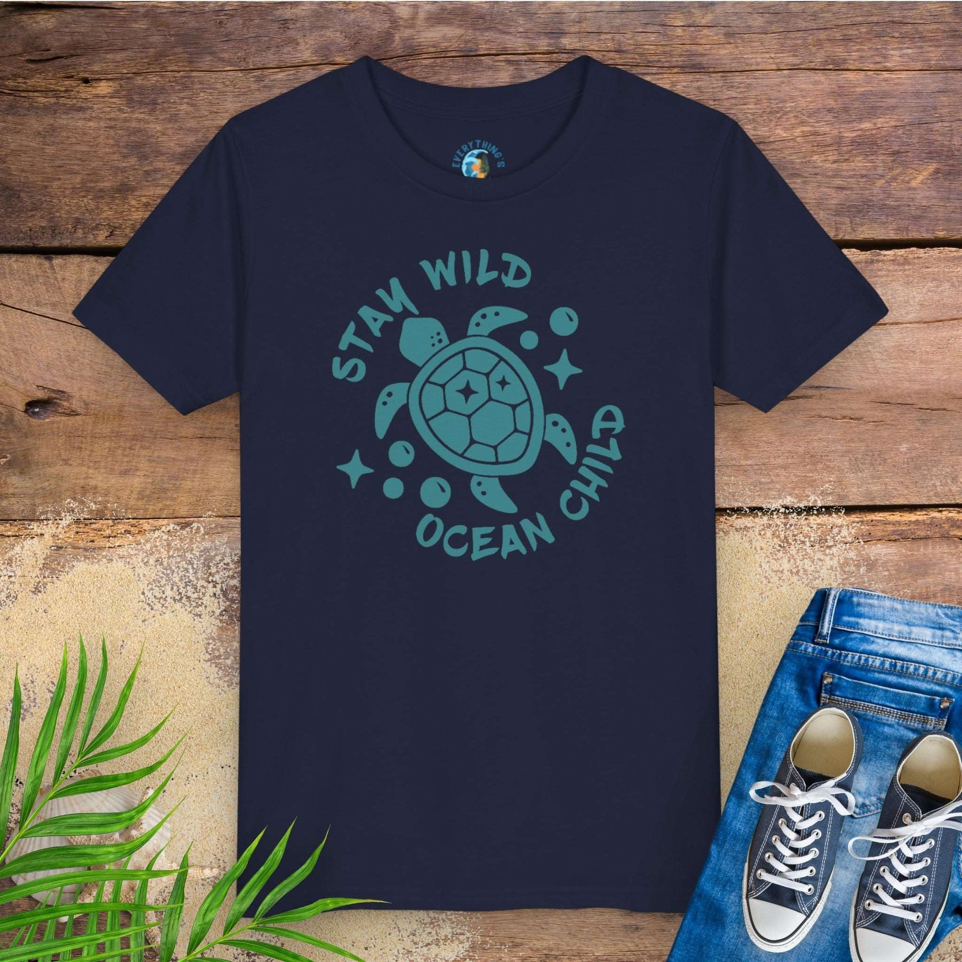 Navy blue t-shirt with sea turtle graphic and text stay wild ocean child.