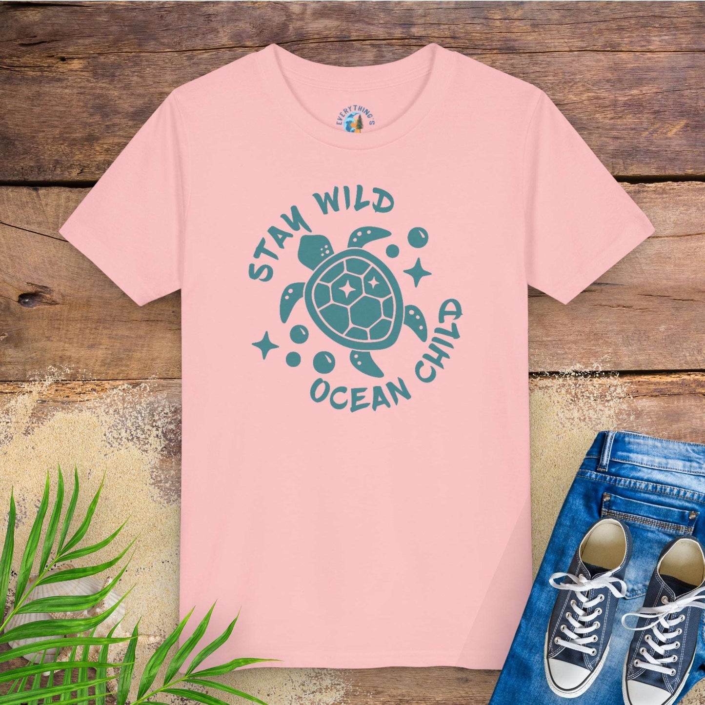 Pink t-shirt with sea turtle graphic and text stay wild ocean child.