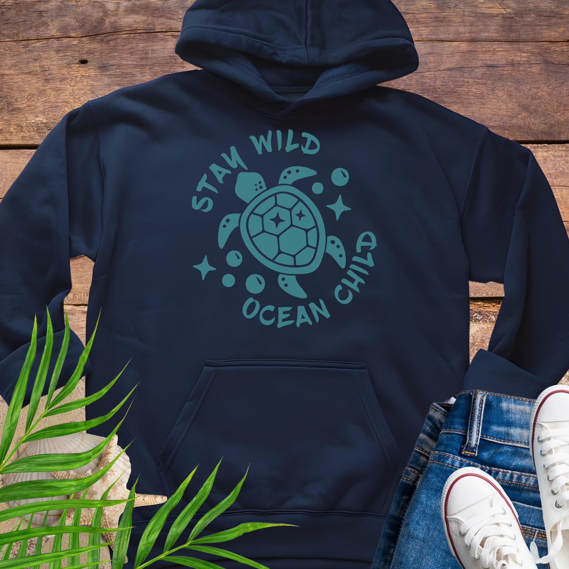 Navy blue hoodie with a sea turtle design and text Stay Wild Ocean Child.