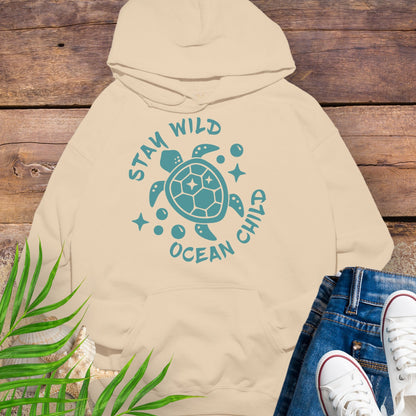 Beige hoodie with a sea turtle design and text Stay Wild Ocean Child.
