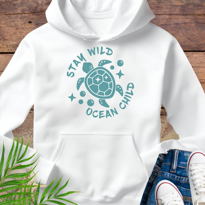 White hoodie with a sea turtle design and text Stay Wild Ocean Child.