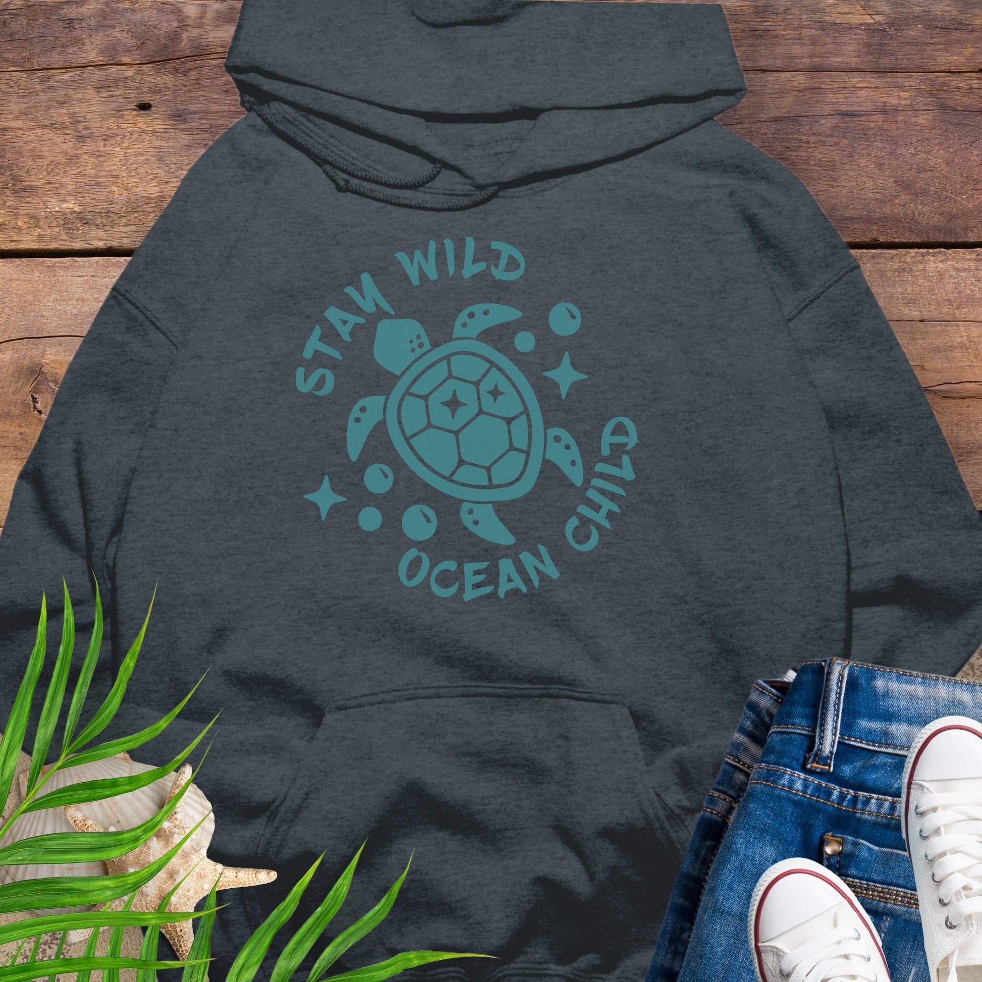 Dark gray hoodie with a sea turtle design and text Stay Wild Ocean Child.