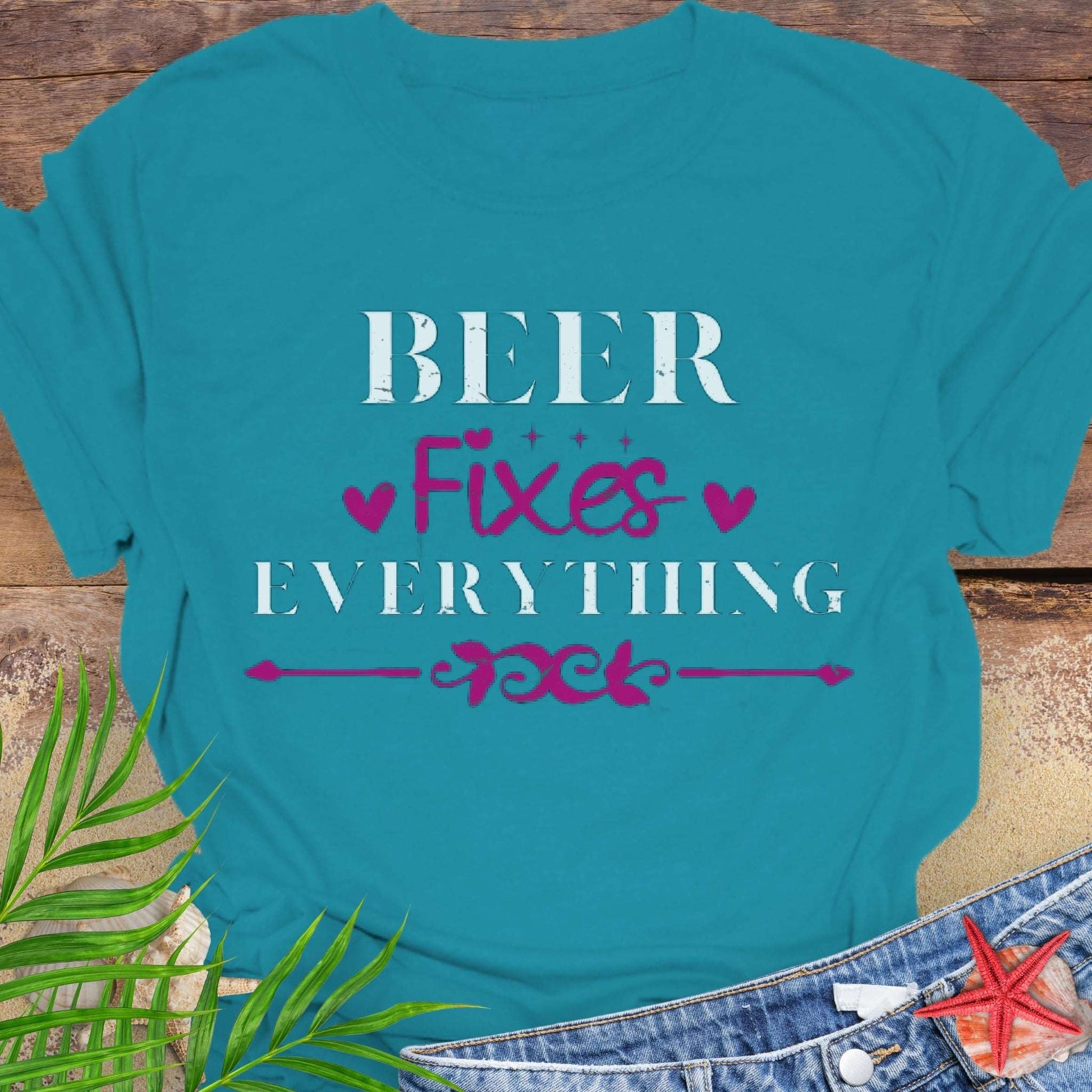 Tropical Blue unisex t-shirt with “Beer Fixes Everything” text and decorative pink hearts and scroll graphic