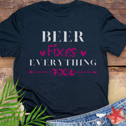 Black unisex t-shirt with “Beer Fixes Everything” text and decorative pink hearts and scroll graphic.