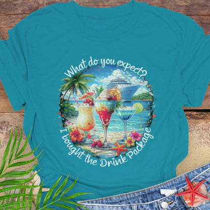 Tropical Blue unisex t-shirt with tropical cocktail and cruise ship graphic and text "What do you expect? I bought the drink package".