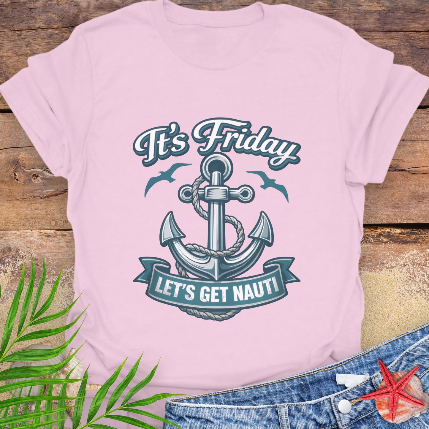 Pink unisex t-shirt with a nautical anchor design and text “It’s Friday Let’s Get Nauti”.